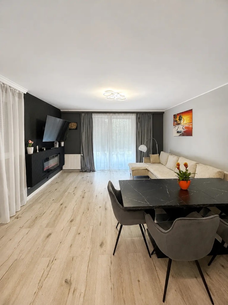 Bright living room with dining table and TV